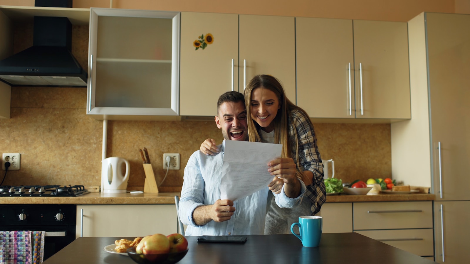 Couple reviewing paperwork in their kitchen