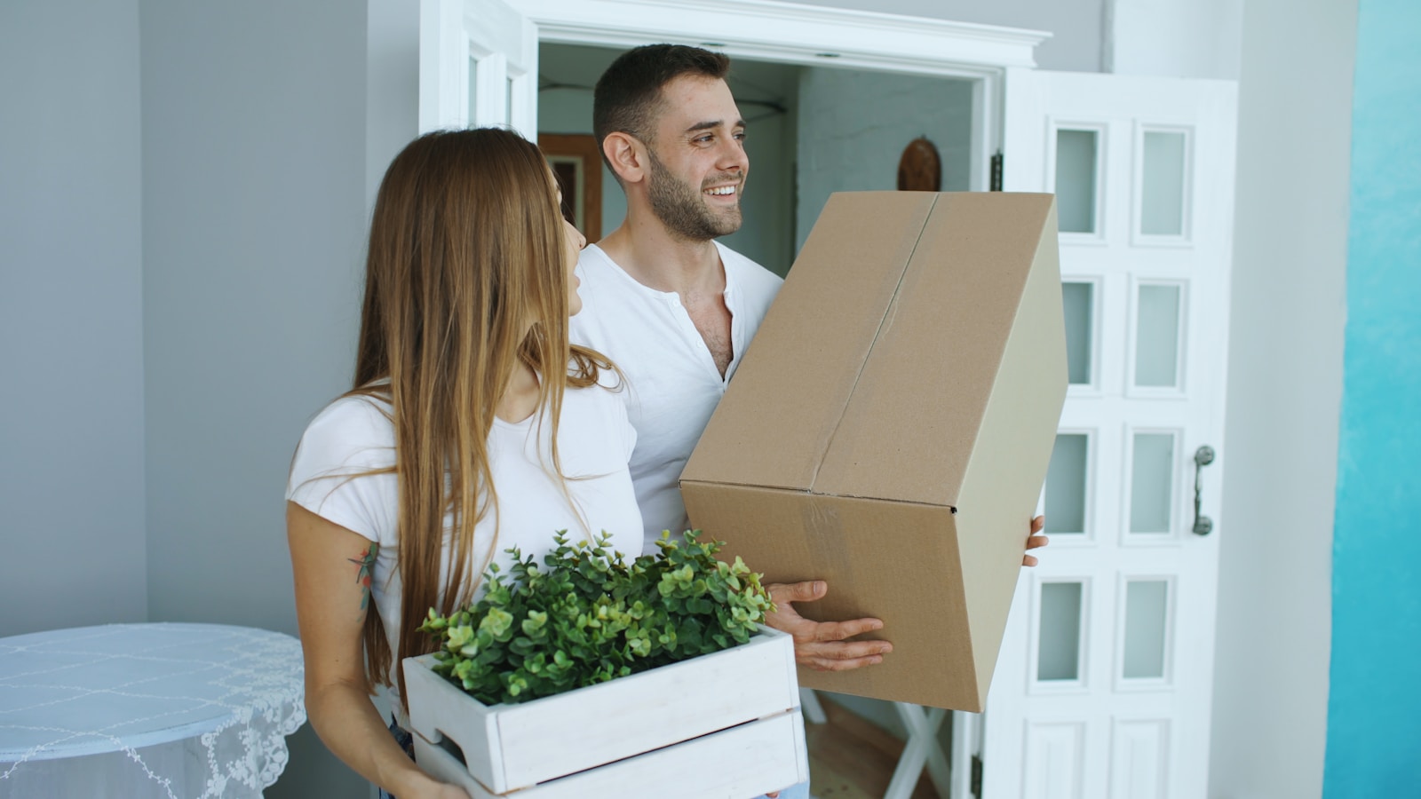 Young couple unpacking boxes in their new home